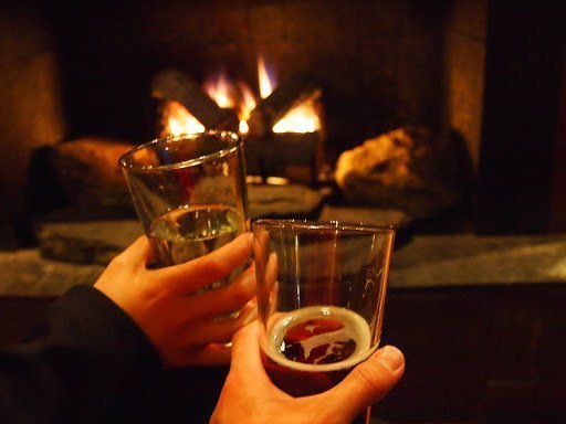 Beer and fireplace during a winter night